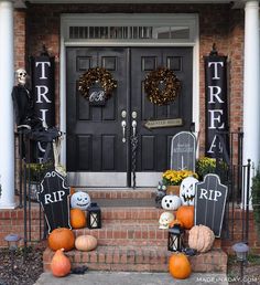 halloween decorations on the front steps of a house