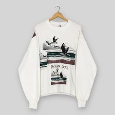 Vintage 90s Birds Ocean City Maryland Sweatshirt Large Laughing Gull Birds Graphics Sweater Birds Wildlife Habitat White Crewneck Size L Good Used Condition. Have minor yellowish stain, REFER PICTURE. Size (On Tag) : Size L **To make sure if it FITS YOU, refer at the exact measurements. Size Measurement (All measurements were taken lying flat) : Width [armpit to armpit] : 23 inches / 58 cm Length [shoulder to end of garment] : 26 inches / 66 cm THIS IS USED CLOTHING! PLEASE DON`T EXPECTED IT TO White Vintage Sweatshirt With Relaxed Fit, White Vintage Sweatshirt Relaxed Fit, 90s Style White T-shirt For Winter, 90s White T-shirt For Winter, 90s Cotton Sweater With Graphic Print, 90s Style White Crew Neck Sweater, Oversized 90s Sweater With Graphic Print, Oversized 90s Graphic Print Sweater, White Crew Neck Sweater In 90s Style