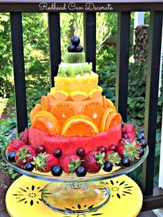 a cake made out of watermelon, oranges and strawberries