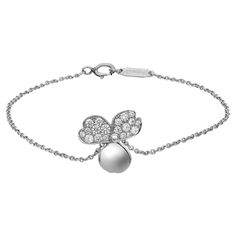 Sleek and modern Tiffany & Co. Paper Flowers diamond chain bracelet. Crafted in lustrous platinum. This bracelet features a center flower charm studded with round brilliant cut diamonds on two petals. Total diamond weight: 0.17 carat. Bracelet length: 6.5 inches. Flower size: 12.4mm. Total weight: 2.60 grams. Secured with a spring ring lock closure. Super stackable and easy to wear. Comes with a Tiffany box and pouch. Diamond Chain Bracelet, Tiffany And Co Bracelet, Tiffany Box, Diamond Chain, Tiffany And Co, Flower Charm, Round Brilliant Cut Diamond, Tiffany & Co., Spring Rings