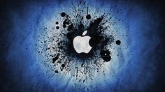 an apple logo is in the middle of some black and blue paint splatters