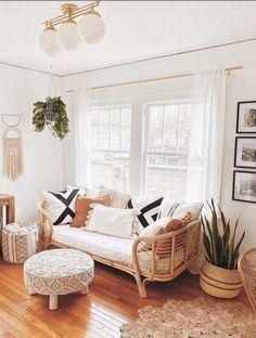 a living room filled with lots of furniture and decor on top of a hard wood floor