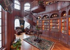 a large library with lots of bookshelves and stairs