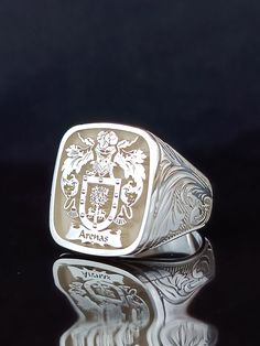 You can ask us all questions. *Logo area: Square * The width of the logo area is 19*19mm. *There are special embroideries on the side arms of the ring. *I can make our rings in 10K, 14K, 18K and 22K gold. *The ring is 925 Sterling Silver. *The ring has my Brand and 925K stamp on it. * Extra discount is provided for 3 or more product orders. *Before the rings are prepared, a design will be sent to you for your approval. After the product is prepared, a photo of the finished product will be sent to you and will be shipped after you approve it. *All our products are guaranteed. *Rings are free on the side arms. (Clan) * Any personalization you want to print on the ring is free. *If permanent gold plating is desired, MICRON PLATING can be applied. It is plated with 0.5 grams of pure gold. *If Luxury Engraved Ring With Coat Of Arms, Signet Ring Family Crest Market Square Jewelers, Classic White Engraved Personalized Ring, Anniversary Silver Engraved Ring, Classic Engraved Ring With Logo As Gift, Classic Engraved Ring With Logo For Gift, Silver Jewelry With Engraved Logo For Gift, Oval Engraved Ring With Coat Of Arms, Classic Rings With Engraved Logo For Gift