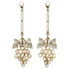 An impressive pair of antique Victorian seed pearl and 15k yellow gold, 9k yellow gold and platinum set drop earrings; part of our diverse antique jewellery collections These fine and impressive antique pearl earrings have been crafted in 15k and 9k yellow gold with platinum settings. Each drop earring has a bunched grape design, the grapes represented by a total of thirty-six natural seed pearls. Each bunch is ornamented to the upper border with a platinum set paired leaf design, and suspends f Luxury Victorian Style Clip-on Earrings, Victorian Earrings Antiques, Victorian Drop Earrings, Art Deco Drop Earrings, Grape Design, Grape Earrings, Natural Pearl Earrings, Platinum Earrings, Antique Earrings