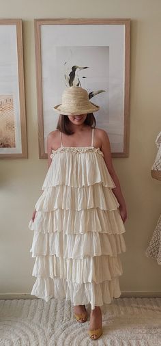 This handmade Bohemian dress is crafted from 100% organic cotton. Its flowing silhouette and tiered layers embody a free-spirited charm, making it a perfect choice for warm days while promoting sustainable craftsmanship. Beach Cotton Tiered Dress, Beach Tiered Cotton Dress, Bohemian Tiered Dress With Ruffles For Garden Party, Bohemian Flowy Tiered Dress For Garden Party, Flowing Cotton Tiered Dress For Beach, Flowy Cotton Tiered Beach Dress, Flowy Cotton Tiered Dress For The Beach, Flowy Bohemian Tiered Dress For Garden Party, Flowy Tiered Cotton Dress With Ruffle Hem