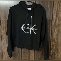 Women’s Large Calvin Klein Black Pullover Crop Hoodie Nwt. Measures Approximately 26” From Armpit To Armpit. Approximately 11” From Armpit To Bottom Of Garment. Sleeves Measure Approximately 16 1/2” From Armpit To End Of Sleeve. Msrp $59.50. Drawer A Trendy Black Calvin Klein Tops, Calvin Klein Long Sleeve Fall Hoodie, Calvin Klein Long Sleeve Hoodie For Fall, Calvin Klein Hooded Hoodie For Fall, Calvin Klein Logo Print Sweatshirt For Fall, Calvin Klein Sporty Hoodie For Streetwear, Calvin Klein Hoodie Sweatshirt For Fall, Calvin Klein Hooded Sweatshirt For Fall, Calvin Klein Winter Hoodie With Drawstring Hood