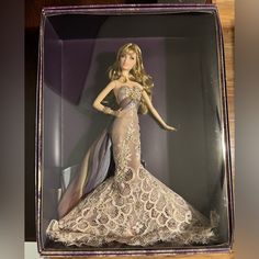 a barbie doll is displayed in a box