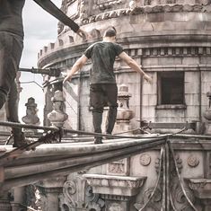 a man standing on top of a metal structure