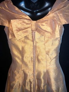 "Made by Harry Keiser, this is a dreamy organza dress in a lovely golden amber color. It has a grand sweeping hemline, a very light dress, you will want to wear a half slip under it, especially for reaching the fuller effect of the skirting. The only flaw is a black mark on the back, minor at best. I always recommend dry cleaning before wearing any vintage clothing. Bust 32-34\" Waist 26\" Hips free fitting Length from shoulder to hem is 47\"" Vintage Ball Gown Dresses For Gala, Vintage Gown With Fitted Bodice For Gala, Vintage Gala Gown With Fitted Bodice, Vintage Spring Gala Dresses, Vintage Ball Gown For Gala, Silk Vintage Evening Dress For Vintage Events, Vintage Silk Ball Gown, Vintage Festive Evening Dress For Party, Vintage Silk Party Gown