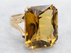 Get ready to make a statement with this ring! Crafted with stunning yellow gold and a sparkling emerald cut citrine stone, this cocktail ring will add a touch of brilliance to any outfit. Perfect for special occasions or just to add some flair to your everyday look.Metal: 10K Yellow GoldGem: Citrine 15.61 CaratsGem Measurements: 14.3 x 17.7 mm, Emerald CutRing Size: 6Marks: "10K-PS" Stamped on the inside band Yellow Citrine Ring, Right Hand Ring, Split Shank Ring, Emerald Cut Rings, Gold Cocktail Ring, Right Hand Rings, Hand Ring, Yellow Citrine, Citrine Stone