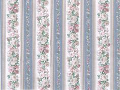 a blue and white striped wallpaper with pink flowers on the side, along with vertical stripes