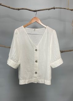 "Classic white and black women V-neck button down blouse, easy to be layered with camisole as a shirt or by itself as a blouse. The puffy sleeves are very flattering; pair it with pants, jeans or skirts for a chic and young look. - Prewashed linen - Relaxed fit - Button down opening - Elbow-length puffed sleeves with cuff and button - Can be tucked or untucked Please provide your shoulder width, full bust measurement ( measured around the fullest part) and your height in the note to seller box. Relaxed Fit V-neck Blouse With Buttons, Summer V-neck Blouse With Button Cuffs, V-neck Top With Button Cuffs For Day Out, Summer V-neck Tops With Button Cuffs, White V-neck Blouse With Buttons, Classic Linen Blouse For Day Out, Summer Puff Sleeve Tops With Button Cuffs, V-neck Tops With Buttons, V-neck Blouse With Buttons For Day Out