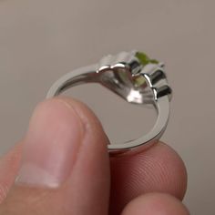 This is a gorgeous handmade creation. Its beauty is its simplicity & Elegance. The 6*6 mm heart cut faceted natural Peridot is crafted in solid sterling silver and with rhodium plated. All item is sent in a beautiful gift box If you have any idea of design your ring,pls contact me directly. You can realize more lovely stuff clicking the link https://www.etsy.com/shop/knightjewelry?refshopsection_shophome_leftnav Please leave the correct address and you phone number for delivering successfull Heart Cut Rings With Bezel Setting, Wedding Ring With Heart Shape For May Birthstone, Green Heart-shaped Promise Ring, Heart Cut Ring With Polished Finish For Promise, Green Heart Cut Ring For Wedding, Heart-shaped Gemstone Ring For May Birthstone, Heart Shaped Gemstone Ring For May Birthstone, Gemstone Heart Ring For May Birthstone, Heart Cut Promise Ring With May Birthstone