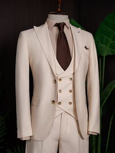 Color: beige Material: 73% polyester, 23% viscose, 4% elastane Suit includes blazer, waistcoat, & trousers Single-breasted suit (2-button blazer) Lapel type: peak lapels Jacket interior lining option: fully-lined Jacket vent: double vent Fitting: modern-fit Care instructions: dry clean only Machine washable: no Fitted Double-breasted Three-piece Suit For Semi-formal, Beige Tuxedo Set For Business, Fitted Double-breasted Three-piece Suit With Single Button, Tailored Beige Sets For Business Casual, Beige Single-breasted Suit For Office, Tailored Beige Formal Sets, Tailored Double-breasted Three-piece Suit With Single Button, Beige Single Breasted Tuxedo Suit, Tailored Beige Sets For Formal Occasions