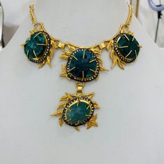 This necklace has beautiful green corundum stone on metal leafy twigs all studded in brass metal with 18K gold plating. It's a perfect go to necklace which can go well with any traditional or indo-western outfit and can enhance your look.This is all handmade necklace. Gold Necklaces With Gemstone Accents For Festive Occasions, Gold Necklace With Gemstone Accents For Festive Occasions, Gold Emerald Pendant Necklace With Natural Stones, Bohemian Gold Jewelry With Emeralds, Bohemian Gold Necklaces With Stone Setting, Bohemian Gold Necklace With Stone Setting, Gold Emerald Jewelry With Gemstone Accents, Festive Handmade Gold Emerald Necklace, Artisan Gold Necklace With Gemstone Accents