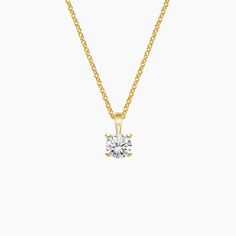 a yellow gold necklace with a single diamond on the front and side, set against a white background