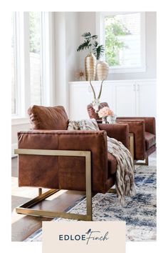 a living room with two brown chairs and a rug