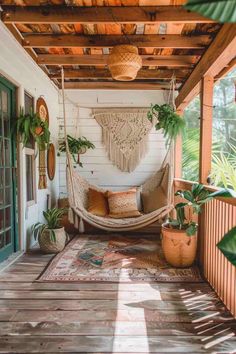 a hammock hanging from the ceiling on a porch