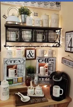 the coffee bar is decorated with mugs, tea cups and other kitchen decor items