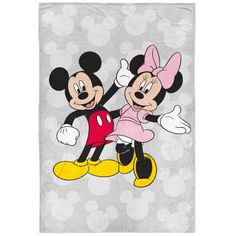 the mickey and minnie towel is shown on a white background, with polka dots in the background