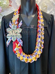 a black graduation gown with red, white and blue ribbons around it's neck