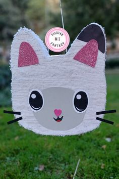 a paper cat decoration hanging from a string