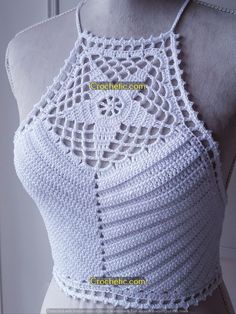 a white crocheted top on a mannequin