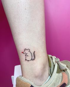 a small mouse tattoo on the ankle