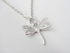 This small dragonfly charm necklace is made of 925 sterling silver. Matching dragonfly earrings: https://shorturl.at/yvrfc The necklace includes: - the dragonfly pendant (size 14 x 15 mm) - a rope, snake, anchor and curb chain (16 to 30 inches) *Add personalized charms with the info below* ADD INITIAL CHARMS: https://etsy.me/3gMPv4r ADD BIRTHSTONE CHARMS: https://etsy.me/3gGTLT4 ADD BIRTHSTONE BEAD CHARMS: https://etsy.me/3gGltzv SILVER POLISHING CLOTH: https://etsy.me/3ieXQyh Looking for more s Sterling Silver Dragonfly Jewelry Gift, Dainty Silver Dragonfly Jewelry, Dainty Sterling Silver Dragonfly Jewelry, Elegant Sterling Silver Dragonfly Jewelry, Dragonfly Shaped Sterling Silver Jewelry Gift, Adjustable Dragonfly Necklace For Gifting, Dragonfly Necklace Silver, Hypoallergenic Sterling Silver Dragonfly Jewelry, Elegant Sterling Silver Dragonfly Necklace