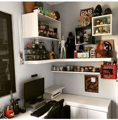 a white desk topped with lots of shelves filled with items