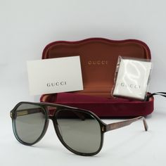 Welcome to OSSA FRAMES, your one-stop destination for luxury eyewear! Introducing the Gucci GG1042S 003 Blue/Brown/Grey aviator sunglasses, the epitome of style and sophistication for the modern man. Crafted by the renowned Italian fashion house Gucci, these sunglasses exude effortless elegance with their sleek design and high-quality materials. The frame color in an exquisite shade of blue perfectly complements the cool grey lenses, creating a striking contrast that is sure to turn heads wherever you go. The acetate frame material ensures durability and comfort, while the 60mm lens socket width provides ample coverage for optimal sun protection. With a temple length of 145mm and a bridge size of 13mm, these sunglasses are designed to fit comfortably on a variety of face shapes and sizes. Luxury Brown Shield Sunglasses With Gradient Lenses, Designer Brown Shield Sunglasses With Gradient Lenses, Designer Brown Shield Sunglasses With Tinted Lenses, Designer Brown Shield Sunglasses With Polarized Lenses, Vintage Gucci Sunglasses With Gradient Lenses, Vintage Gucci Sunglasses With Tinted Lenses, Vintage Gucci Tinted Sunglasses, Designer Aviator Sunglasses With Mirrored Lenses, Designer Aviator Sunglasses With Tinted Lenses