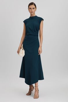 Find REISS Jessa Ruched Midi Dress on Editorialist. Engineered with stretch to hug the waist, this midi dress is cut with a high neckline, cap sleeves, and a ruched side. It zips close and features an oversized tie element to the back of the neck. High neckline Cap sleeves Ruche detailing Zip closure to reverse Tie back Midi length Donna Suits, Business Fits, Teal Outfits, Royal Wardrobe, Studded Mini Dress, Autumn Dresses, Work Photos, Wedding Outfit Ideas, Gamine Style