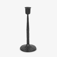 a black candle holder on a white background