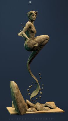 a statue of a mermaid sitting on top of rocks and water with bubbles coming out of it