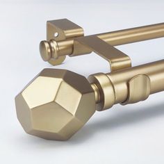 an image of a gold curtain rod with knobs on the top and bottom part