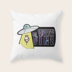 a pillow with the words everything is totally fine on it, and an alien hat