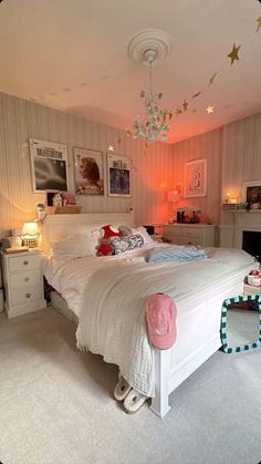 a white bed sitting in a bedroom next to a fire place