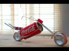 a miniature coca - cola cart made out of tin cans