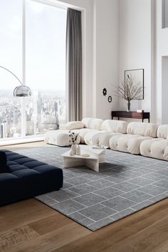 a modern living room with large windows overlooking the city