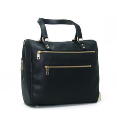 a black handbag with gold zippers on the front and side pockets, sitting against a white background