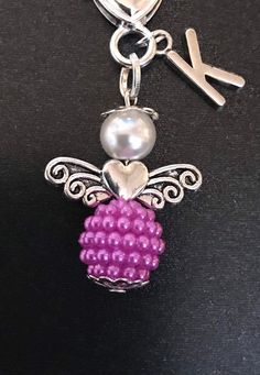 a key chain with a beaded bee on it