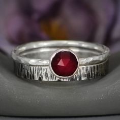 "This lovely sterling silver promise ring set features our rose cut garnet stacking ring paired with a simple and striking narrow birch bark patterned band. This ring set is perfect for anyone who loves simple nature inspired designs and prefers a low profile ring mounting! For the Ring: The band of this ring is made of a sturdy round Sterling Silver wire that has been given a hammer texture, then carefully polished for a bright finish. This ring features a 6 mm rose cut garnet cabochon that has Nature Inspired Engagement Ring, Stack Rings, Promise Ring Set, Sterling Silver Promise Rings, Buy Jewellery Online, Sterling Silver Stacking Rings, Hammered Ring, Stacking Ring Set, Hammered Rings