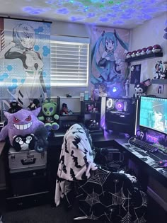 a room filled with lots of stuffed animals and toys on top of a desk in front of a computer monitor