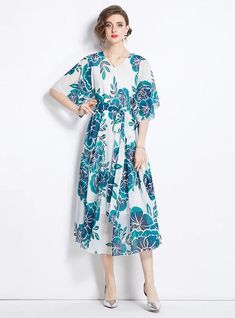 Breezes through every occasion with elegance, this floral midi dress is crafted for the modern woman who values both style and comfort. The light blue and navy floral patterns pop against the white background, creating a refreshing visual appeal. This dress features a loose fit, ensuring it drapes gracefully over any body type, while the mid-length and wide sleeves provide coverage yet maintain a breezy feel. Ideal for brunches, office wear, or weekend outings, it’s versatile enough for various Lace Embroidery Dress, Blooming Garden, Black Dress With Sleeves, White Belt, White Backdrop, Fabric Belt, Flowy Skirt, Loose Dress, Embroidery Dress