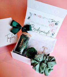 an open box with some green hair accessories in it and a note on the inside