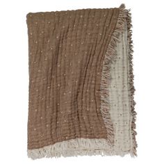 a brown and white blanket with fringes on it's edges, against a white background