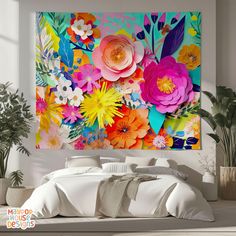 a large flower painting on the wall above a bed