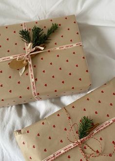 two wrapped presents are sitting on a bed