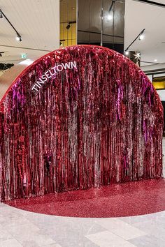 a large red sculpture in the middle of a lobby